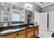 Bathroom featuring double sink vanity, soaking tub, and dark granite countertops at 2294 Hollonville Rd, Brooks, GA 30205