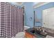 Bathroom with a granite countertop, mosaic tile backsplash, and a checkered shower curtain at 2294 Hollonville Rd, Brooks, GA 30205