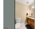 Well-lit powder room features a granite countertop, cherry cabinet, and framed mirror at 2294 Hollonville Rd, Brooks, GA 30205