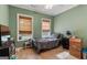 Cozy bedroom with green walls and two windows for natural light, ceiling fan, and baseboard trim at 2294 Hollonville Rd, Brooks, GA 30205