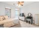 Bright bedroom featuring two windows, neutral carpet, a white dresser, and a vanity area at 2294 Hollonville Rd, Brooks, GA 30205