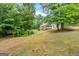 Home back elevation highlighting yard, exterior and the spacious back deck and porch at 2294 Hollonville Rd, Brooks, GA 30205