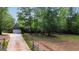 Home with a two car garage, mature landscaping, and a long driveway leading up to the house at 2294 Hollonville Rd, Brooks, GA 30205
