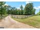 Scenic drive and fenced-in yard create a welcoming entrance to this lovely home at 2294 Hollonville Rd, Brooks, GA 30205