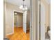 View of an open hallway showing doorways and ceramic tiled flooring with decorative light fixture at 2294 Hollonville Rd, Brooks, GA 30205