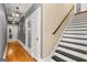 Hallway with hardwood flooring and staircase, illuminated by hanging pendant lights at 2294 Hollonville Rd, Brooks, GA 30205