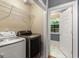 Laundry room featuring modern washer and dryer, and a tiled floor at 2294 Hollonville Rd, Brooks, GA 30205