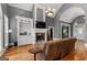 Comfortable living room features stone fireplace, built-in shelving, and hardwood floors at 2294 Hollonville Rd, Brooks, GA 30205