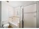 Bright bathroom featuring a tub-shower combo with decorative tile accents and a sliding glass door at 3652 Platina Park Ct, Decatur, GA 30034