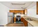 Traditional kitchen featuring wood cabinets, laminate countertops, and stainless steel appliances at 3652 Platina Park Ct, Decatur, GA 30034