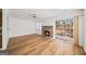 Bright open-concept living area with cozy fireplace, laminate flooring and sliding glass doors to the outdoor deck at 3652 Platina Park Ct, Decatur, GA 30034
