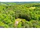 Expansive aerial view of a property with abundant trees and distant mountain views at 3258 South Mckoy Rd, Villa Rica, GA 30180