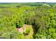 Aerial shot showcases a private residence embraced by a dense forest with a long driveway at 3258 South Mckoy Rd, Villa Rica, GA 30180