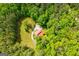 Bird's eye view highlighting the home's wooded surroundings and a winding driveway approach at 3258 South Mckoy Rd, Villa Rica, GA 30180