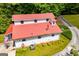 Aerial view of a two-story home with red roof and a lush, green lawn in a wooded area at 3258 South Mckoy Rd, Villa Rica, GA 30180