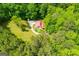 Aerial perspective captures the house among trees, showcasing the greenery and privacy at 3258 South Mckoy Rd, Villa Rica, GA 30180