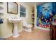 Bathroom with a pedestal sink, decorative window, and whimsical shower curtain at 3258 South Mckoy Rd, Villa Rica, GA 30180