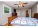 Bedroom with hardwood floors, ceiling fan, a bed, and a doorway to a bathroom at 3258 South Mckoy Rd, Villa Rica, GA 30180