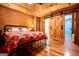 Bedroom features wood paneled walls, ceiling fan, sliding barn door, and view to ensuite bathroom at 3258 South Mckoy Rd, Villa Rica, GA 30180