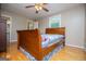 Cozy bedroom with a wood-frame bed, ceiling fan, and hardwood floors at 3258 South Mckoy Rd, Villa Rica, GA 30180