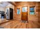 Inviting entryway featuring wood-paneled walls, a stained-glass door, and luxury vinyl plank floors at 3258 South Mckoy Rd, Villa Rica, GA 30180