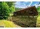 View of a home with a long porch, set against a backdrop of green trees and foliage at 3258 South Mckoy Rd, Villa Rica, GA 30180
