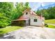 Charming two-story home featuring a metal roof, screened-in porch, surrounded by green foliage at 3258 South Mckoy Rd, Villa Rica, GA 30180