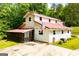 Charming two-story home featuring a metal roof, screened-in porch, and an American flag display at 3258 South Mckoy Rd, Villa Rica, GA 30180