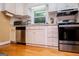 Efficient kitchen with white cabinets, stainless steel appliances, and a window above the sink at 3258 South Mckoy Rd, Villa Rica, GA 30180