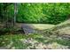 Wood bridge spanning a stream amidst lush green surroundings providing serenity at 3258 South Mckoy Rd, Villa Rica, GA 30180