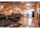 Open-concept living room and kitchen featuring hardwood floors, wood-paneled walls, and a rustic design at 3258 South Mckoy Rd, Villa Rica, GA 30180