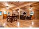 Open-concept living room boasting wood-paneled walls, multiple ceiling fans, and luxury vinyl plank floors at 3258 South Mckoy Rd, Villa Rica, GA 30180