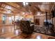 Spacious open-concept living room and kitchen featuring hardwood floors, wood-paneled walls, and a wood stove at 3258 South Mckoy Rd, Villa Rica, GA 30180