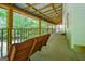 Extended screened porch showcasing a porch swing and view of natural surroundings at 3258 South Mckoy Rd, Villa Rica, GA 30180