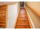 A view up the home's wooden stairway with handrail and a white door and wall at 3258 South Mckoy Rd, Villa Rica, GA 30180