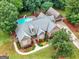 Beautiful aerial view of brick home, pool, lush landscaping, and detached garage at 124 Belford Way, Locust Grove, GA 30248