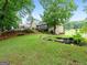Expansive backyard featuring a tranquil pond, lush greenery, and beautiful landscaping at 124 Belford Way, Locust Grove, GA 30248