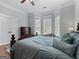 Comfortable bedroom with large windows, hardwood floors, and a cozy bed at 124 Belford Way, Locust Grove, GA 30248