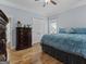 Serene bedroom with hardwood floors, large windows, and a comfortable blue bed at 124 Belford Way, Locust Grove, GA 30248