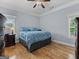 Relaxing bedroom featuring hardwood floors, ample natural light, and stylish decor at 124 Belford Way, Locust Grove, GA 30248