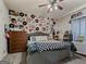 Whimsical bedroom featuring unique wall decor, ceiling fan, and comfortable furniture at 124 Belford Way, Locust Grove, GA 30248