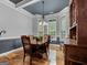 Elegant dining room with hardwood floors, modern chandelier, and large windows at 124 Belford Way, Locust Grove, GA 30248