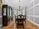Elegant dining room with dark wood table, chairs, hutch and a beautiful chandelier at 124 Belford Way, Locust Grove, GA 30248