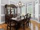 Dining room area features a dark wood dining room table, a hutch, and hardwood floors at 124 Belford Way, Locust Grove, GA 30248