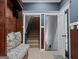 Welcoming entryway with storage bench and staircase, enhanced by natural light at 124 Belford Way, Locust Grove, GA 30248