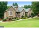 Charming single-Gathering home with brick and stone exterior, manicured lawn, and inviting entrance at 124 Belford Way, Locust Grove, GA 30248