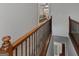 Hallway with hardwood railing overlooking living room and entryway at 124 Belford Way, Locust Grove, GA 30248
