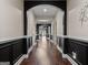Elegant hallway boasts dark trim and hardwood flooring throughout the house at 124 Belford Way, Locust Grove, GA 30248