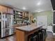 Kitchen with an island, stainless steel appliances and bar stool seating at 124 Belford Way, Locust Grove, GA 30248