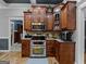 Kitchen features custom wood cabinetry and stainless steel appliances at 124 Belford Way, Locust Grove, GA 30248